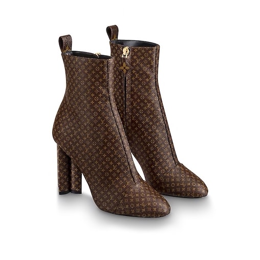 A pair of Louis Vuitton boots in monogrammed canvas with chocolate glace  leather heels and toes and gold tone hardware. Size 37 and come with dust  bag, cloth case and box. (1)